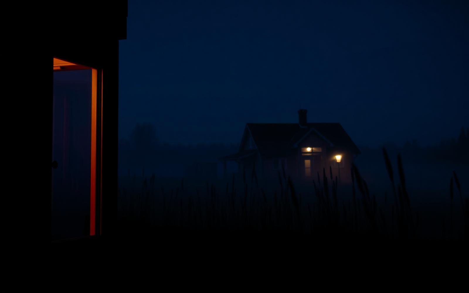 A dimly lit room at night with a linen robe, folded towels and a warm lamp after an evening sauna